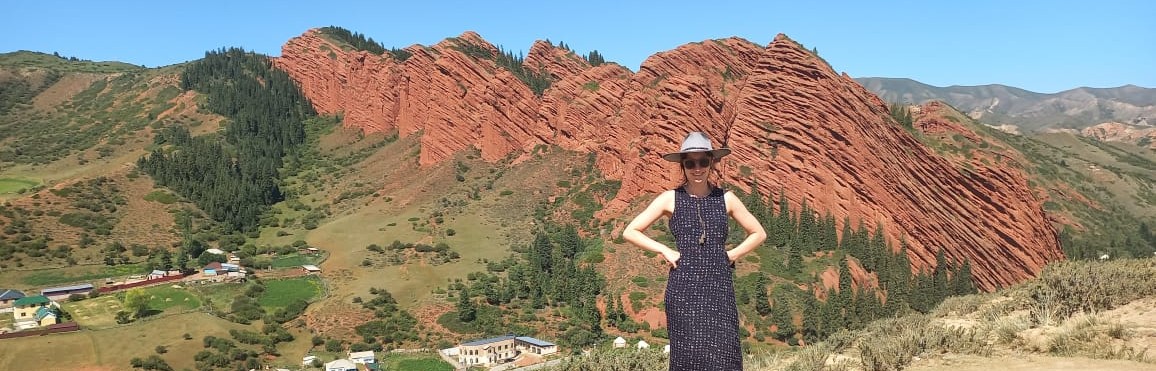 A girl standing in front of Seven Bulls, Kyrgyzstan