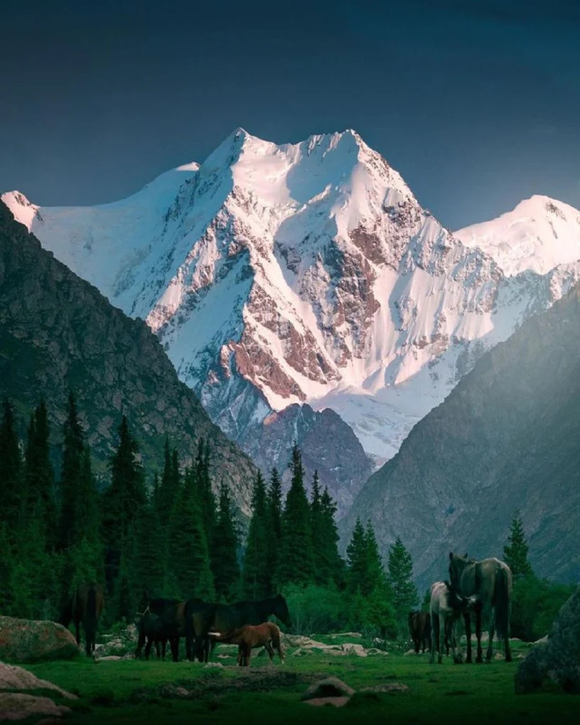 People riding horses in the mountains of Kyrgyzstan